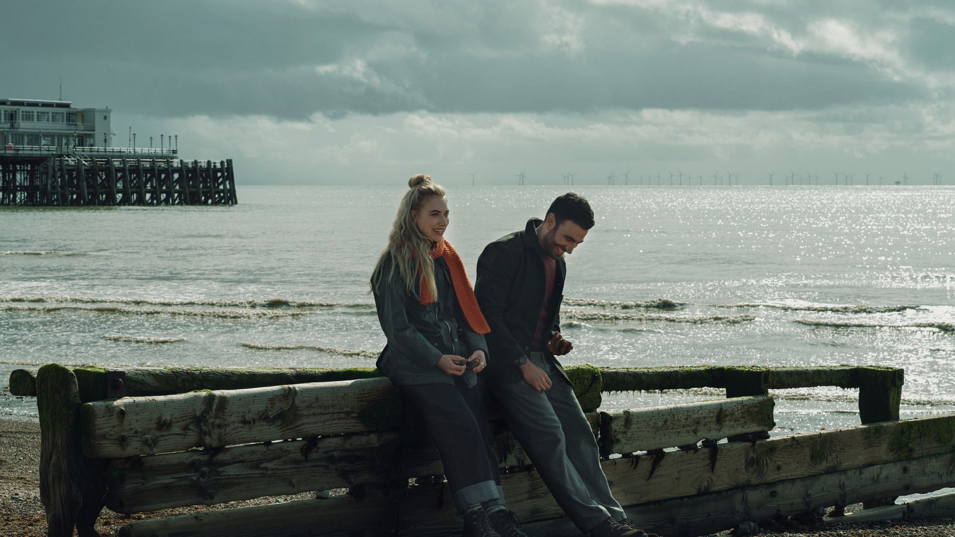 Brett Goldstein and Imogen Poots sitting by a beach in All of You