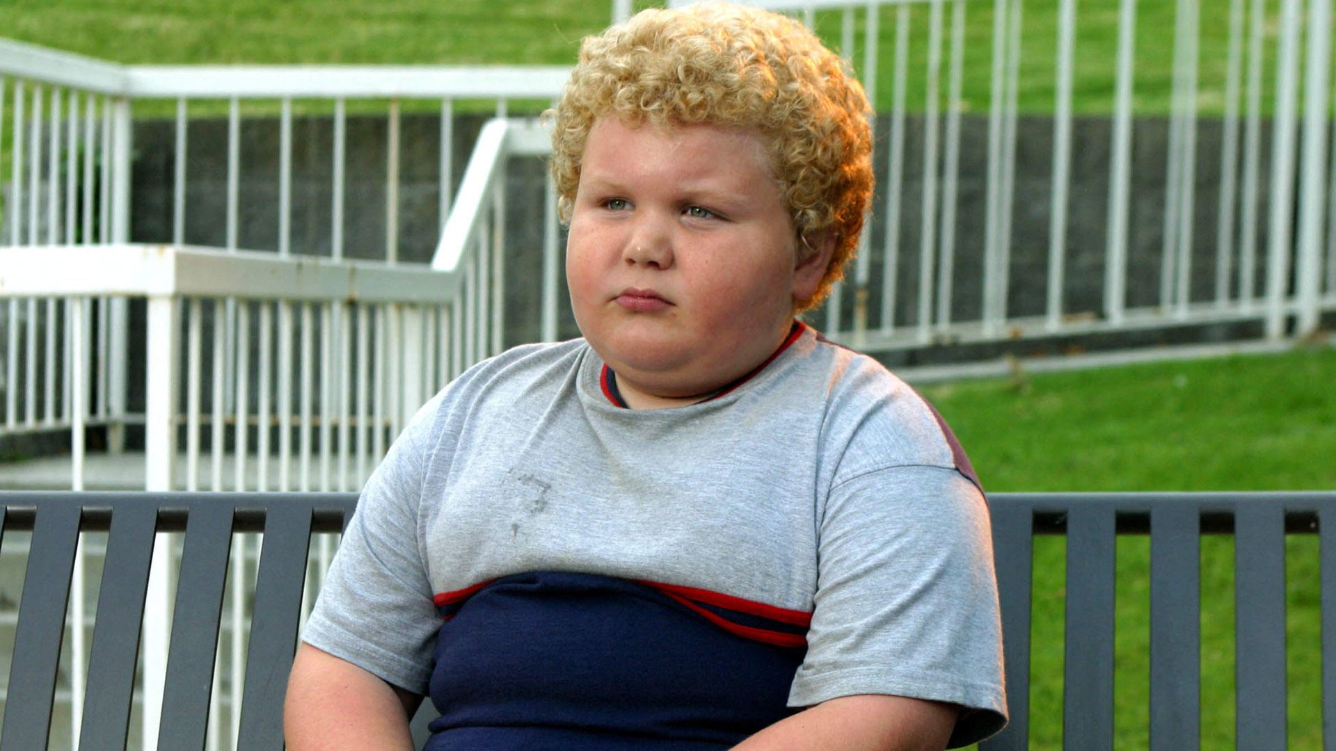Brett Kelly as Thurman Merman in Bad Santa sitting on a bench