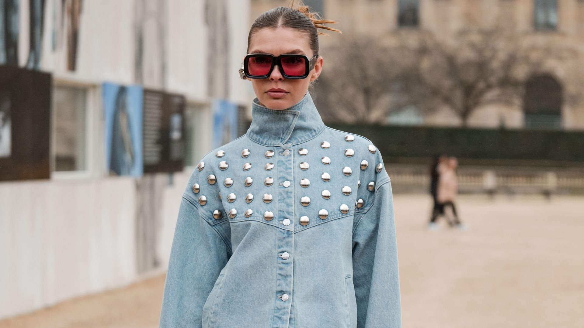 A guest wears light blue denim decorated jacket with matching jeans, outside Off-White, during the Womenswear Fall/Winter 2024/2025 as part of  Paris Fashion Week on February 29, 2024 in Paris, France. (Photo by Claudio Lavenia/Getty Images)