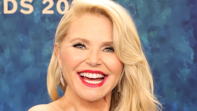 Christie smiling broadly black dress