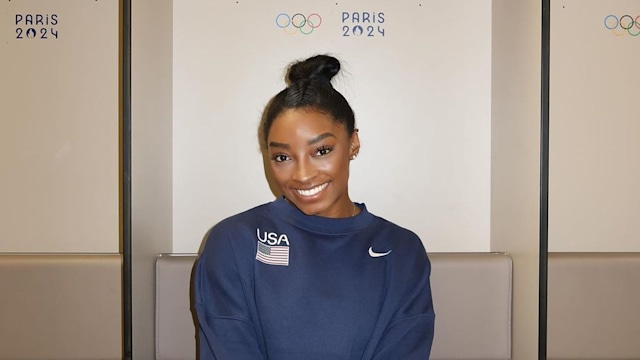 Simone Biles smiles in Olympics dressing room