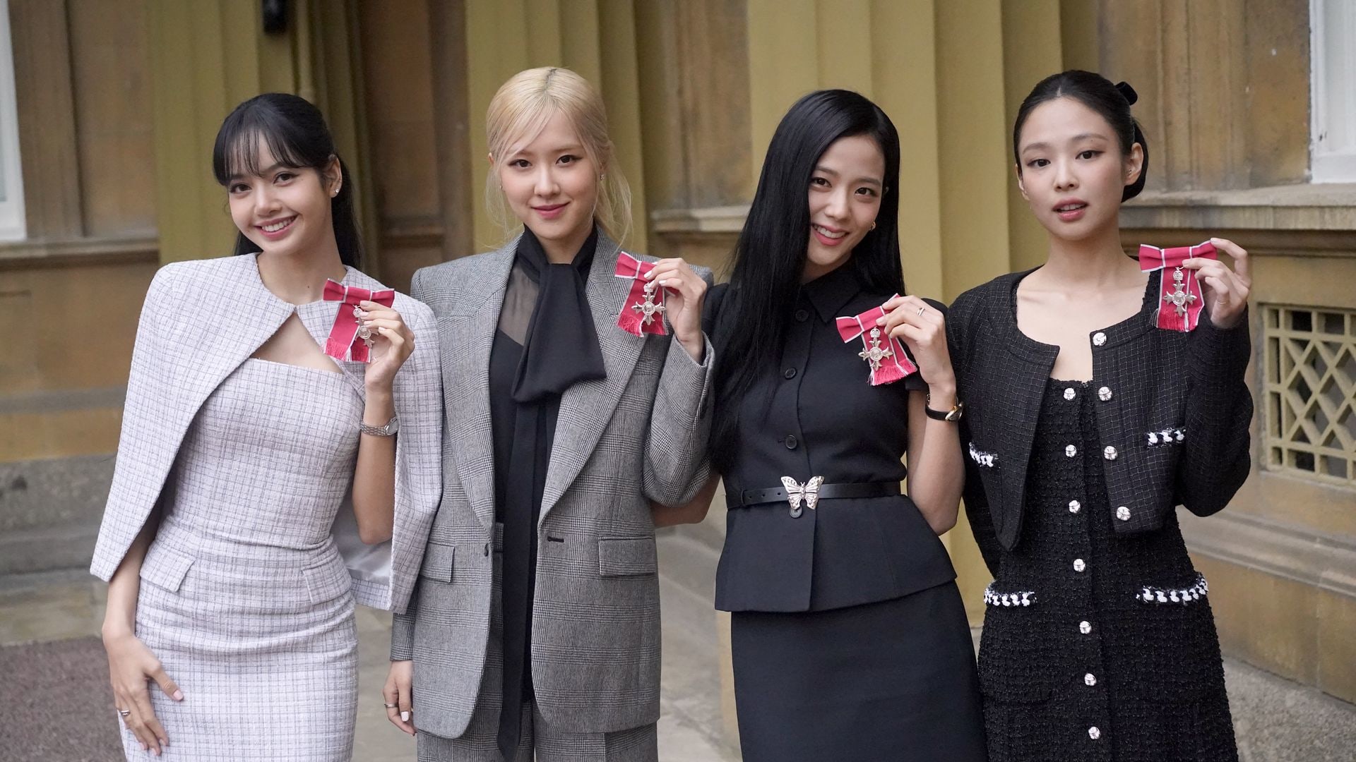 Lisa (Lalisa Manoban), Rose (Roseanne Park), Jisoo Kim and Jennie Kim, from the K-Pop band Blackpink pose with their Honorary MBEs 