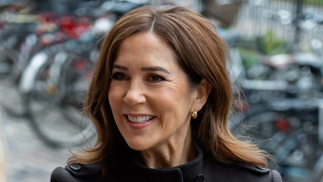 Queen Mary smiling in navy coat 