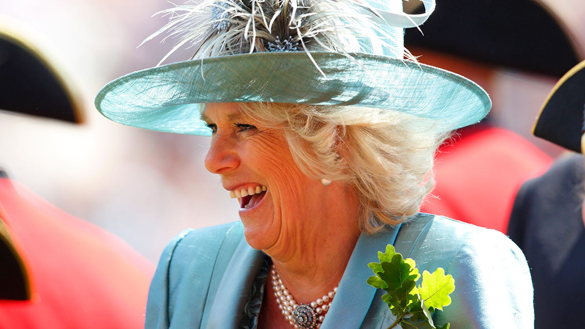 the duchess of cornwall laughs in light blue
