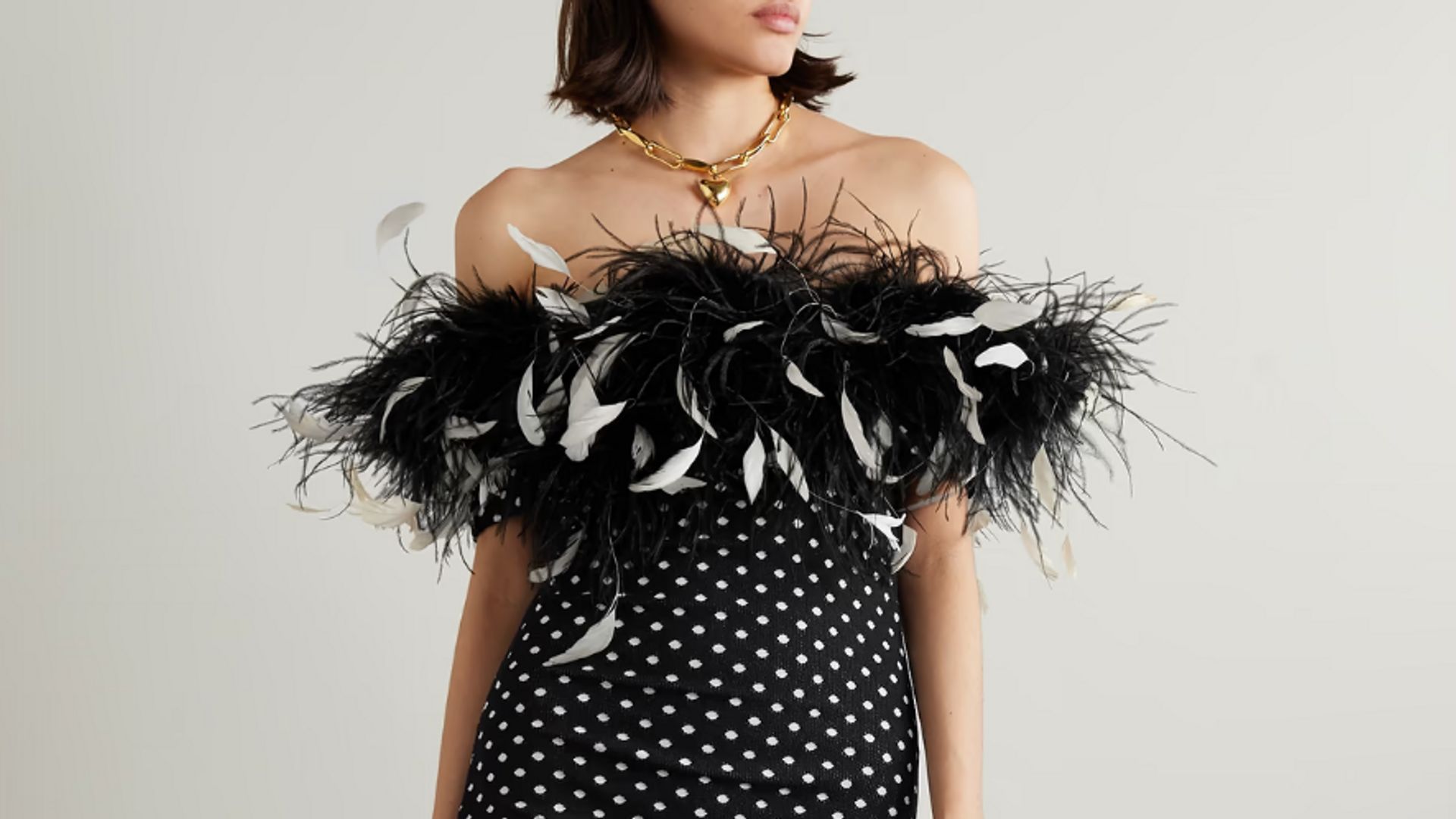 Model wearing feathered Bardot party dress