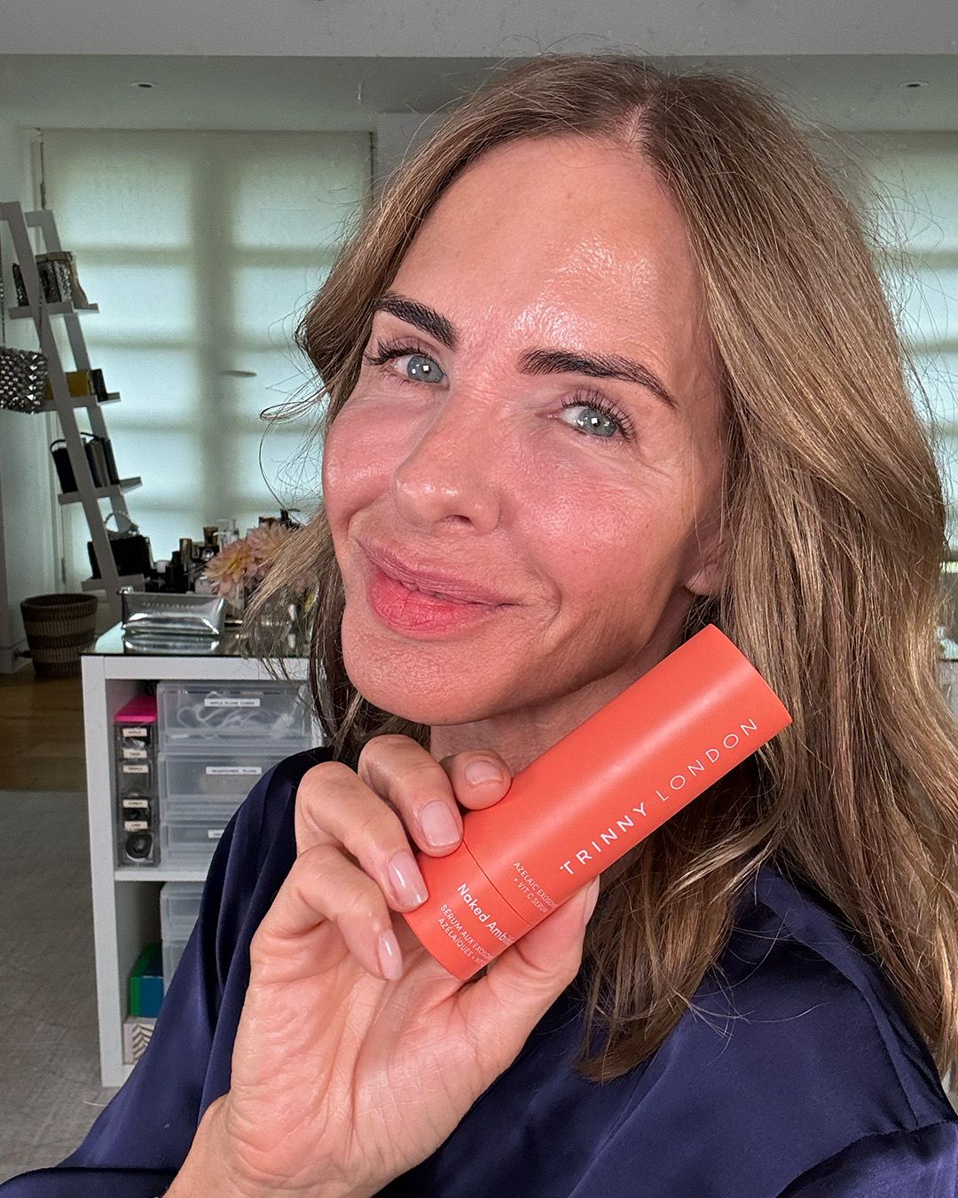 Trinny Woodall posing for a selfie with her new skincare product, Naked Ambition