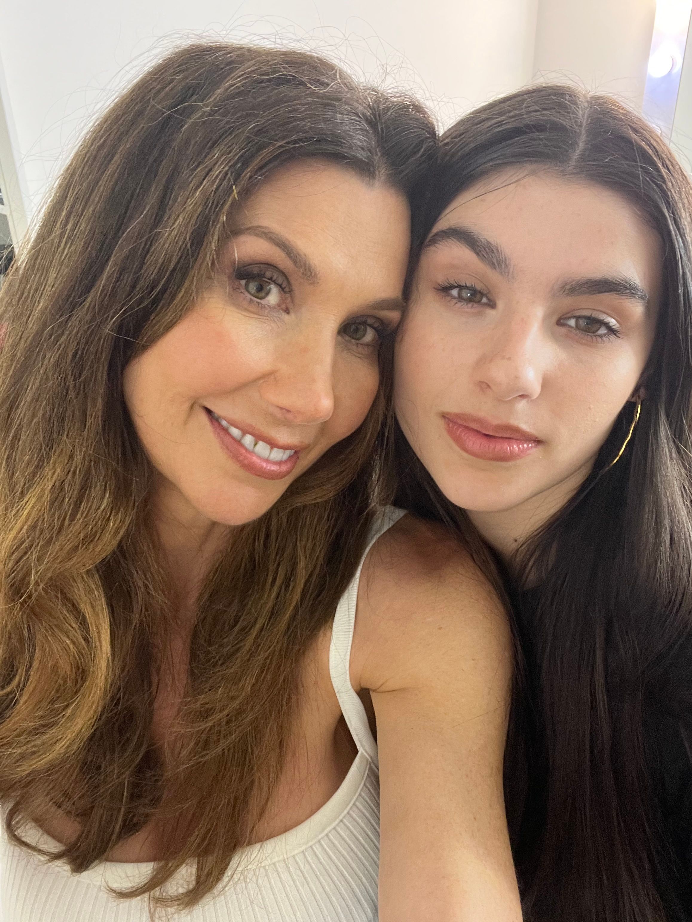 brunette woman smiling with her daughter