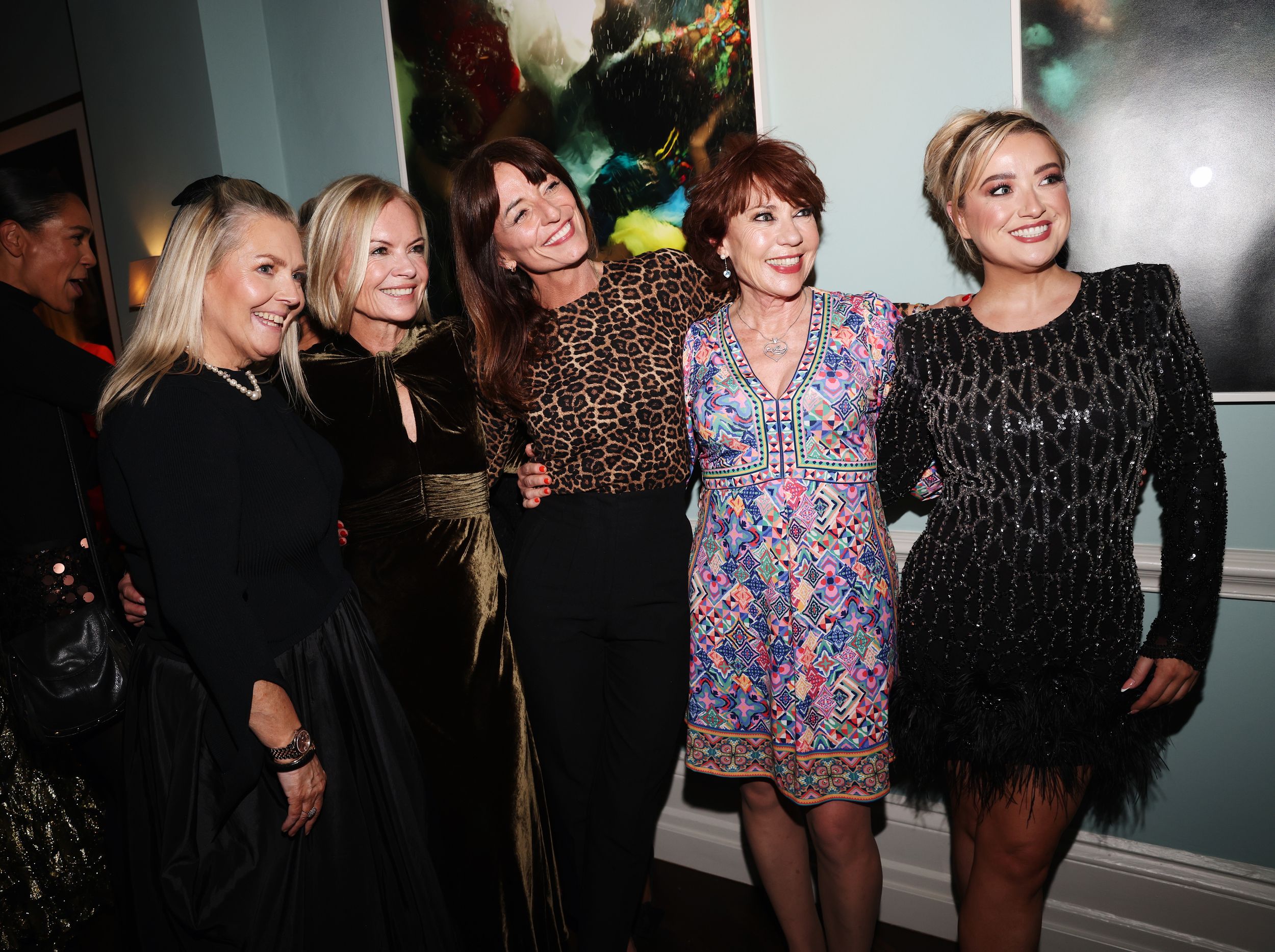 Davina McCall posing with 4 more guests at the Hello Power List Party wearing a leopard top and black trousers