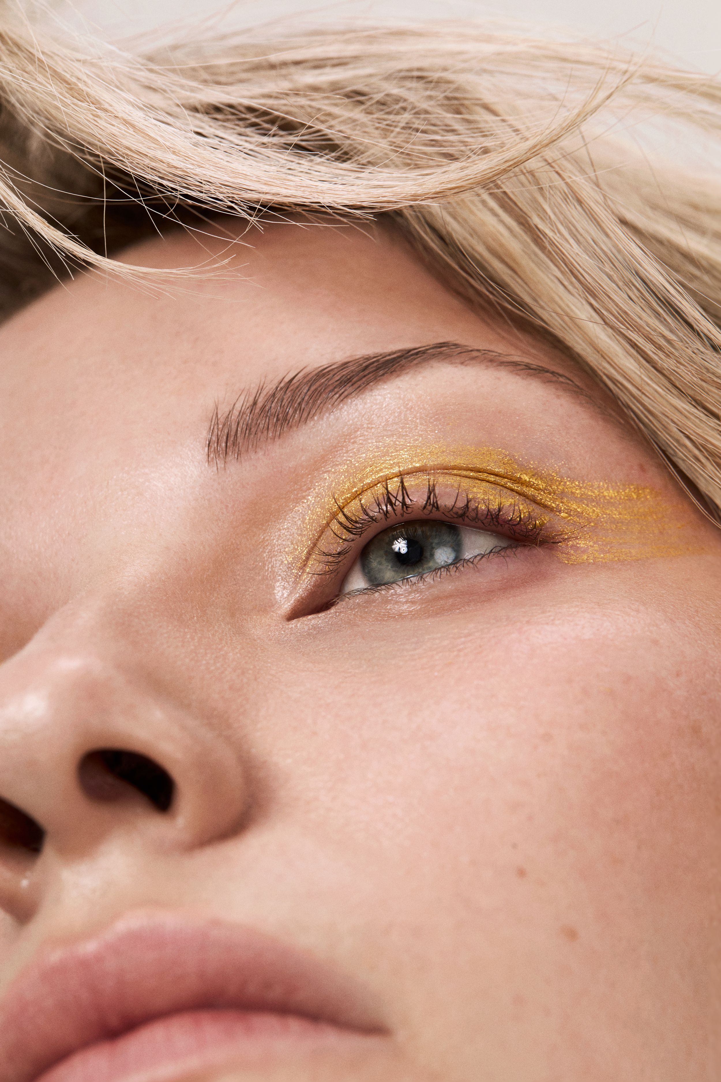 close up of eye with yellow eyeliner 