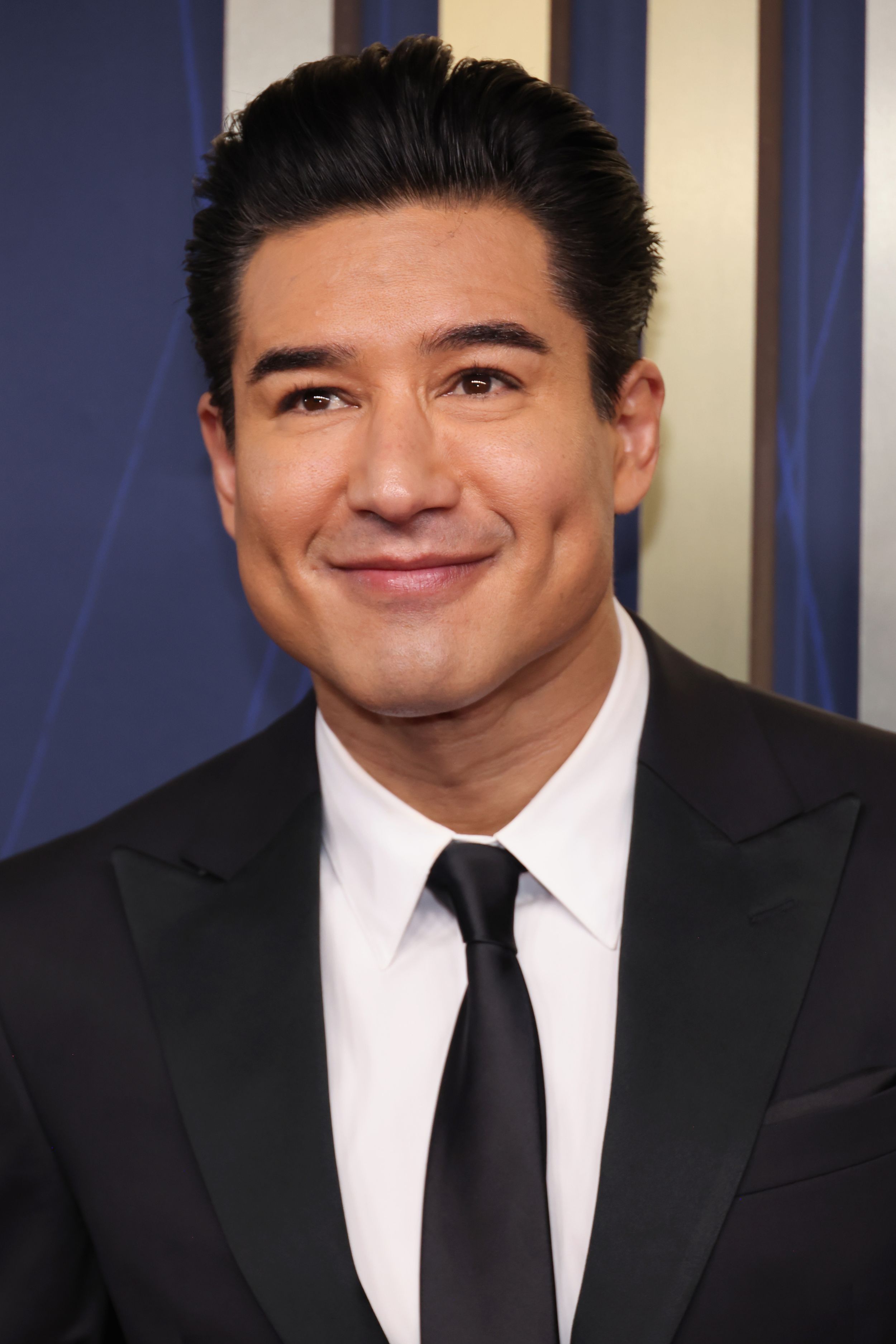Mario Lopez in a black tie suit