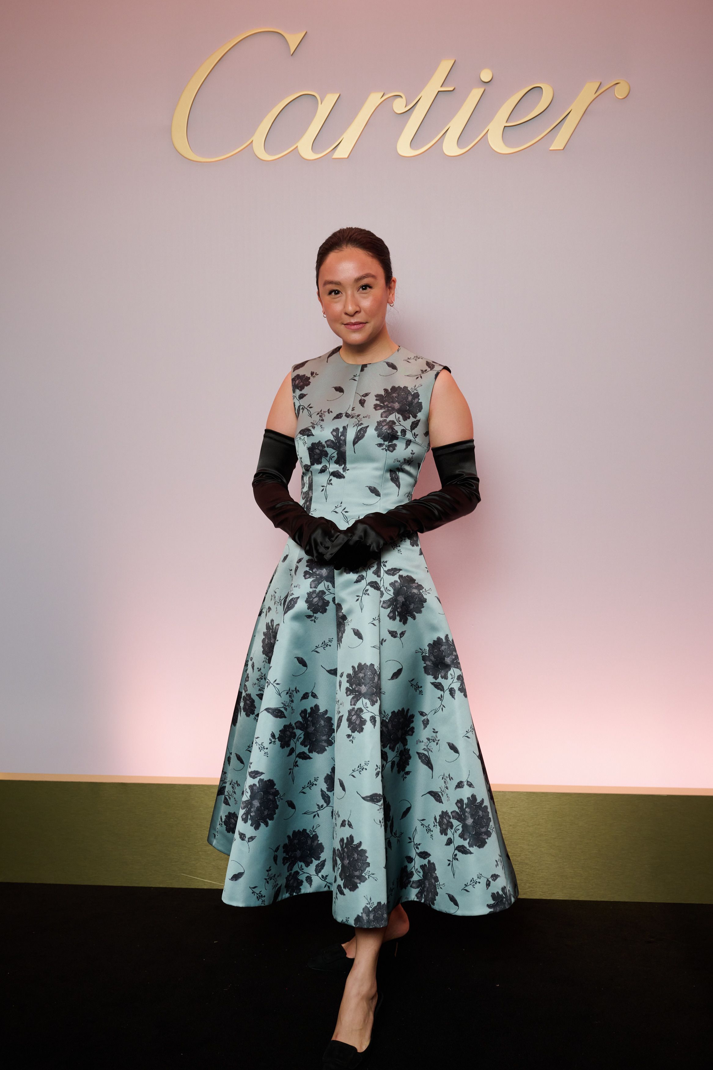 Elle McPherson-Yoon wearing a blue floral dress and elbow length satin gloves