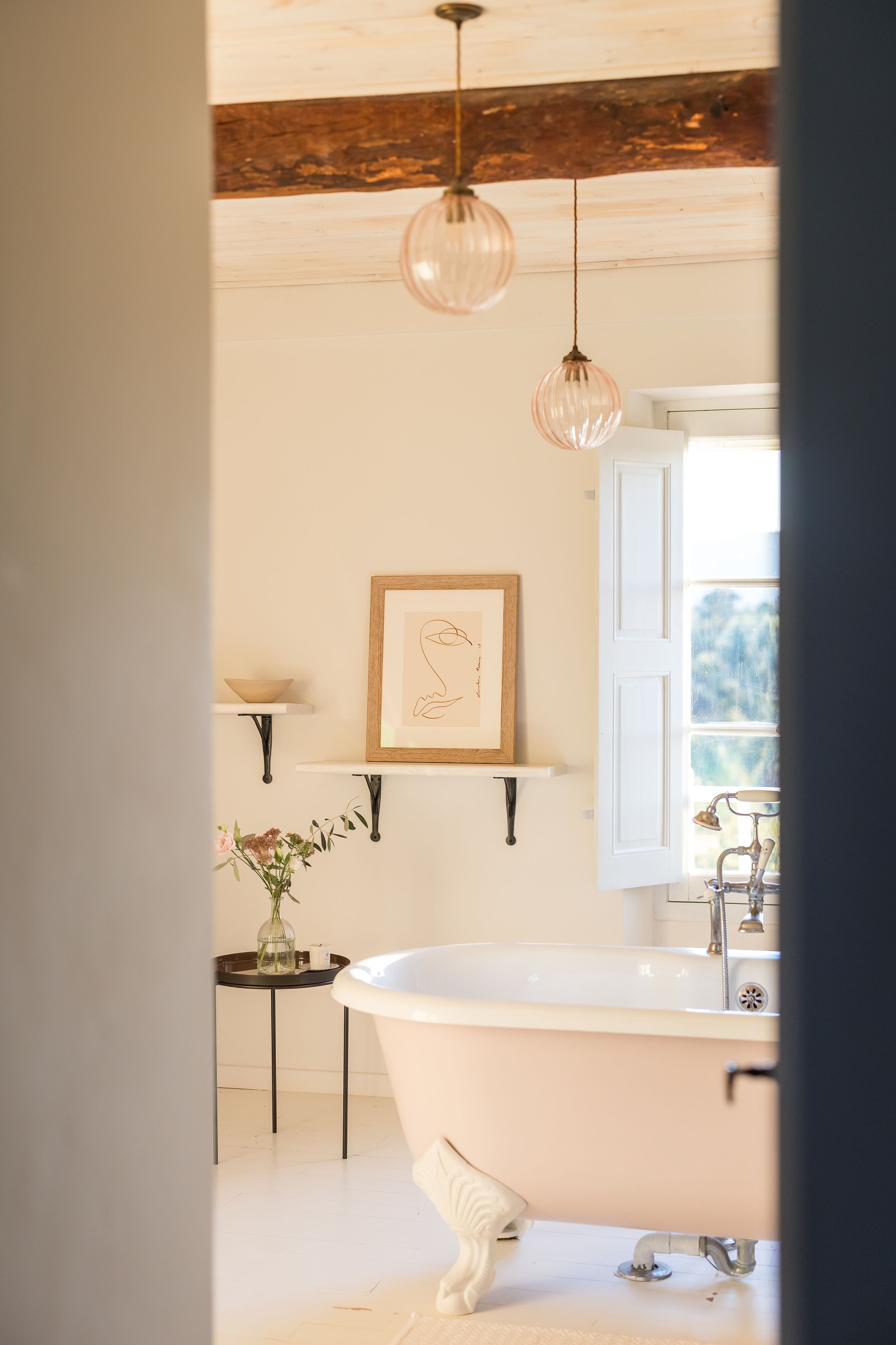 One of the bathrooms, with a huge bathtub and a clean, white theme, in Domaine Mirabeau Provençal manor house,