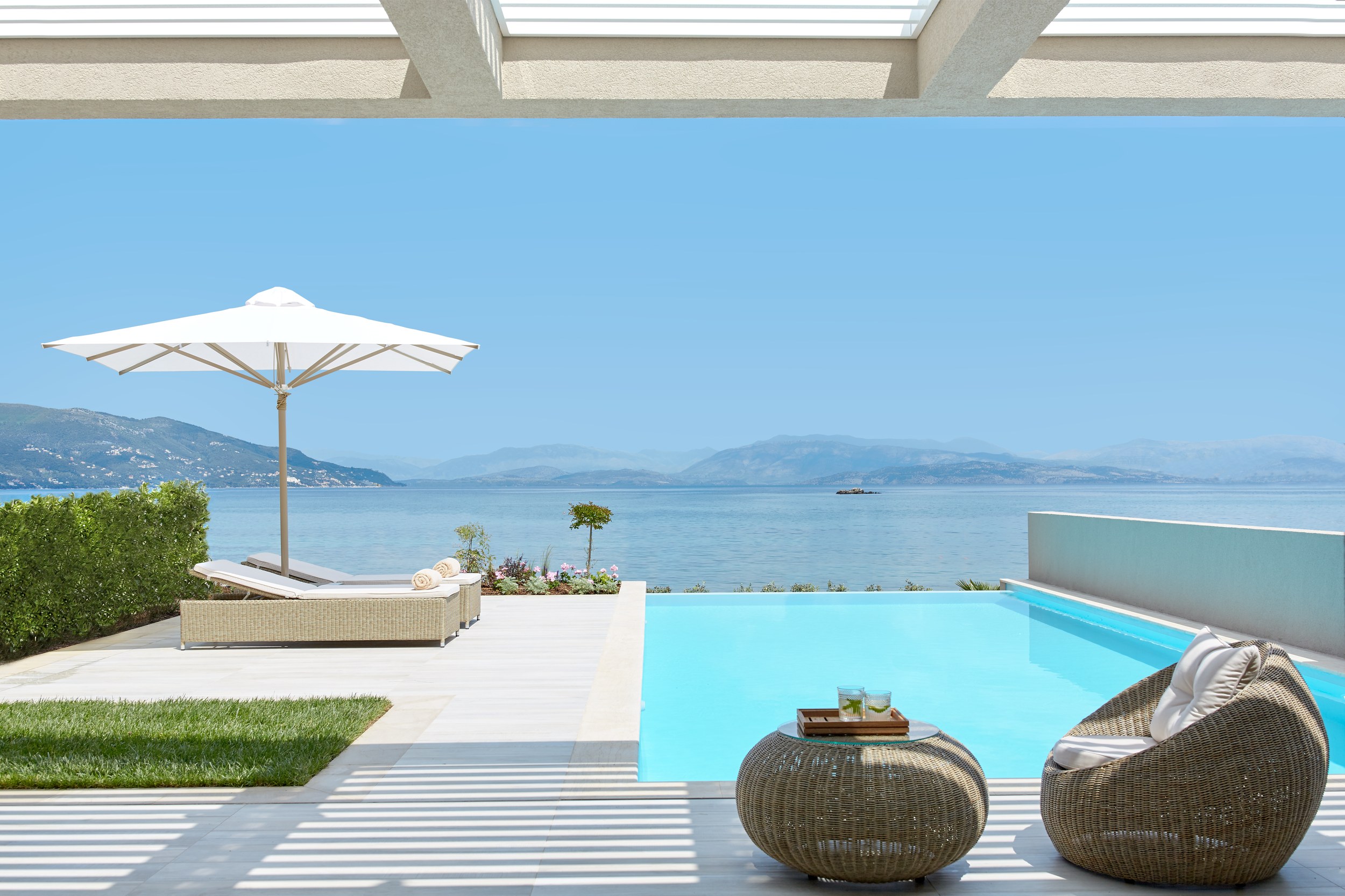 Pool with two sun loungers and mountain in the distance