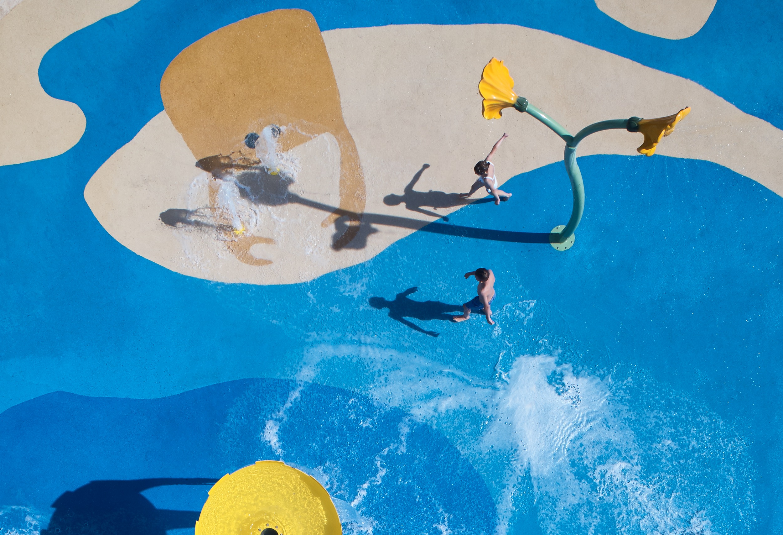 birds eye view of kids playing on a splash pad