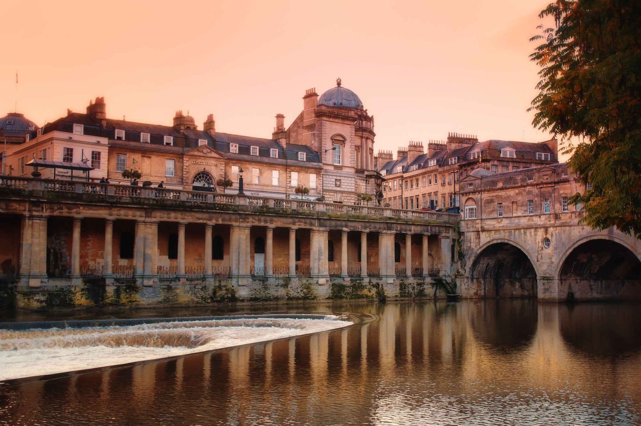 Looking across the weir to Poultney Bridge in Bath as the sun goes down on a summer's evening