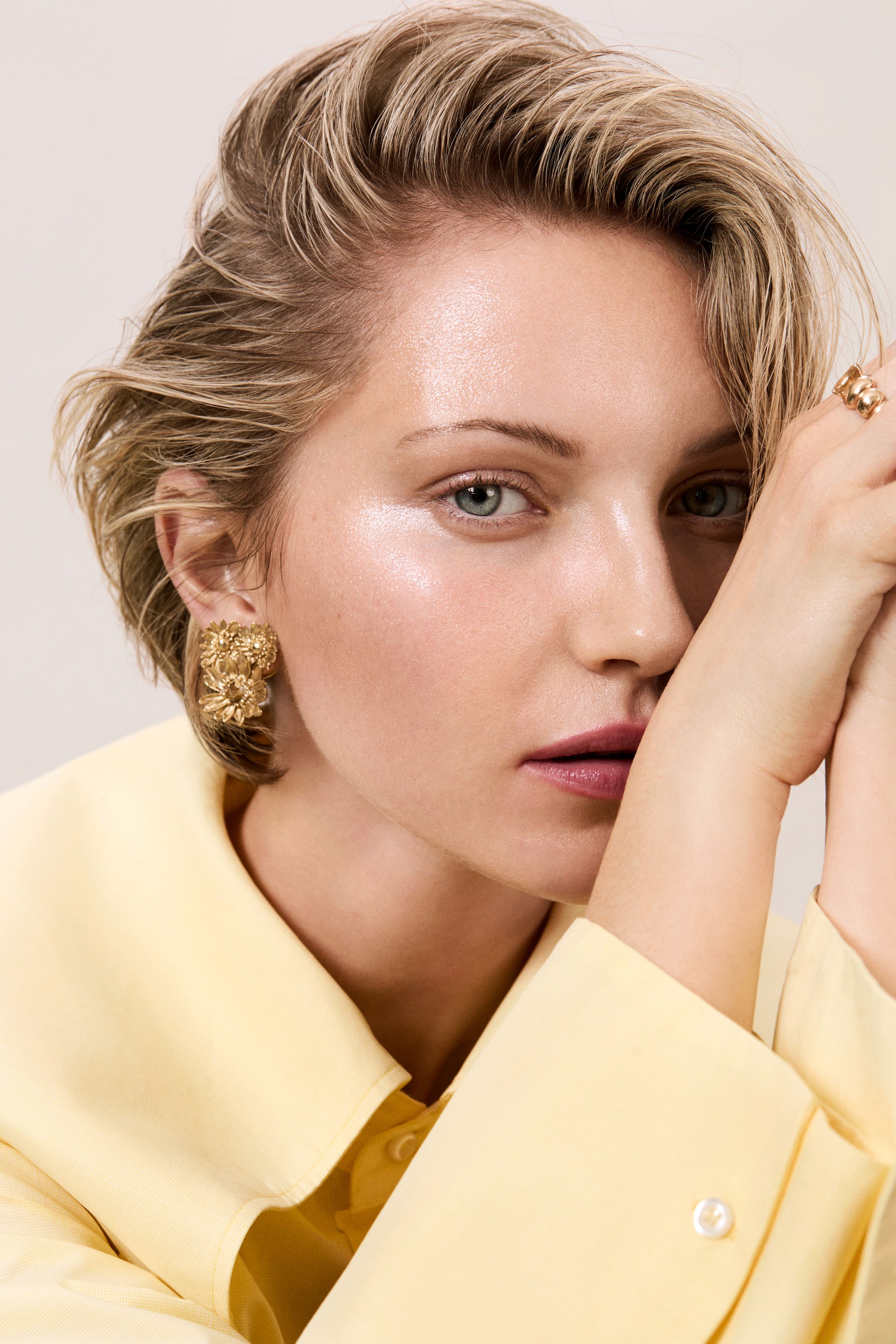 blonde woman in a yellow top looks into the camera