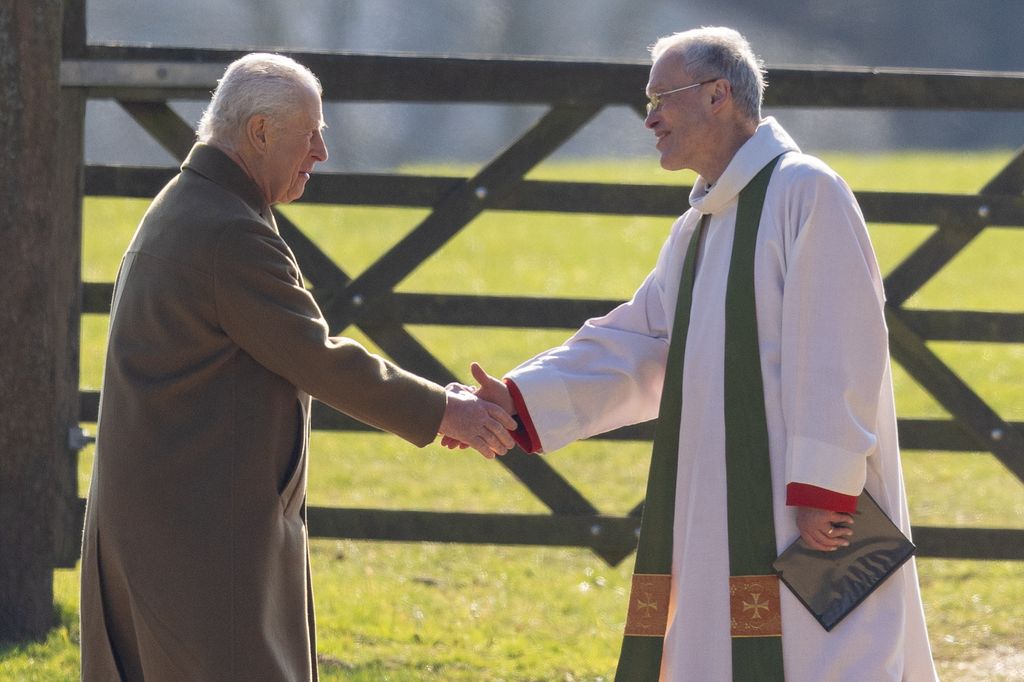 two men shaking hands outside church