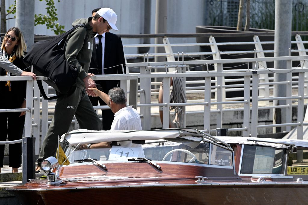 Tom Brady prepares to board a taxi boat after landing at Venice Marco Polo airport 