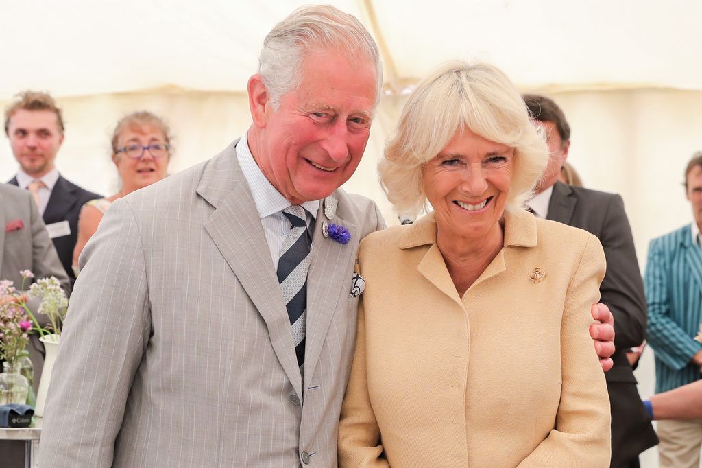 Charles puts his arm around Camilla on her birthday