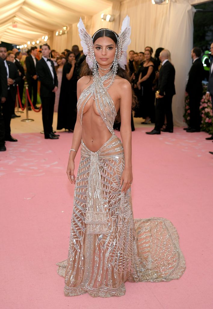 Emily Ratajkowski attends The 2019 Met Gala Celebrating Camp: Notes on Fashion at Metropolitan Museum of Art  in a risque gold dress 