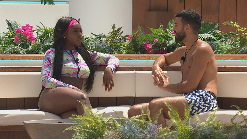 Whitney and Mehdi talk by the firepit in Love Island