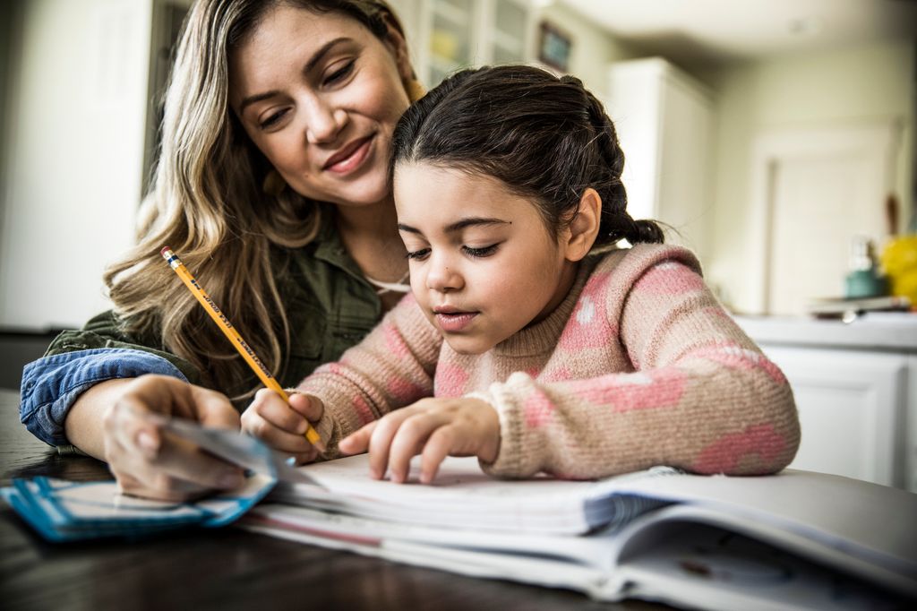 Mother and daughter (7 yrs) doing homework