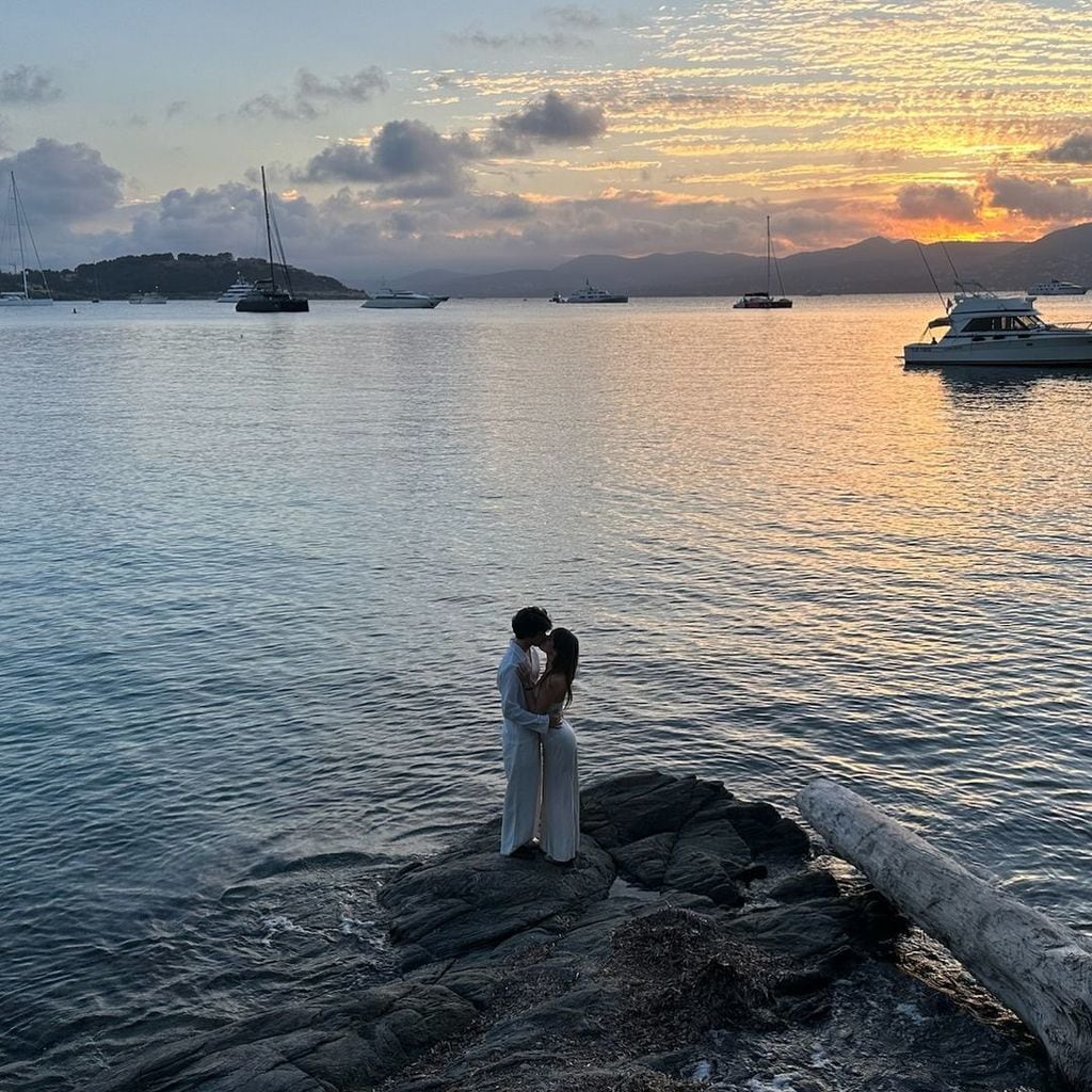 Dylan Lee and fiance Paula Bruss kiss on a rocky outcrop