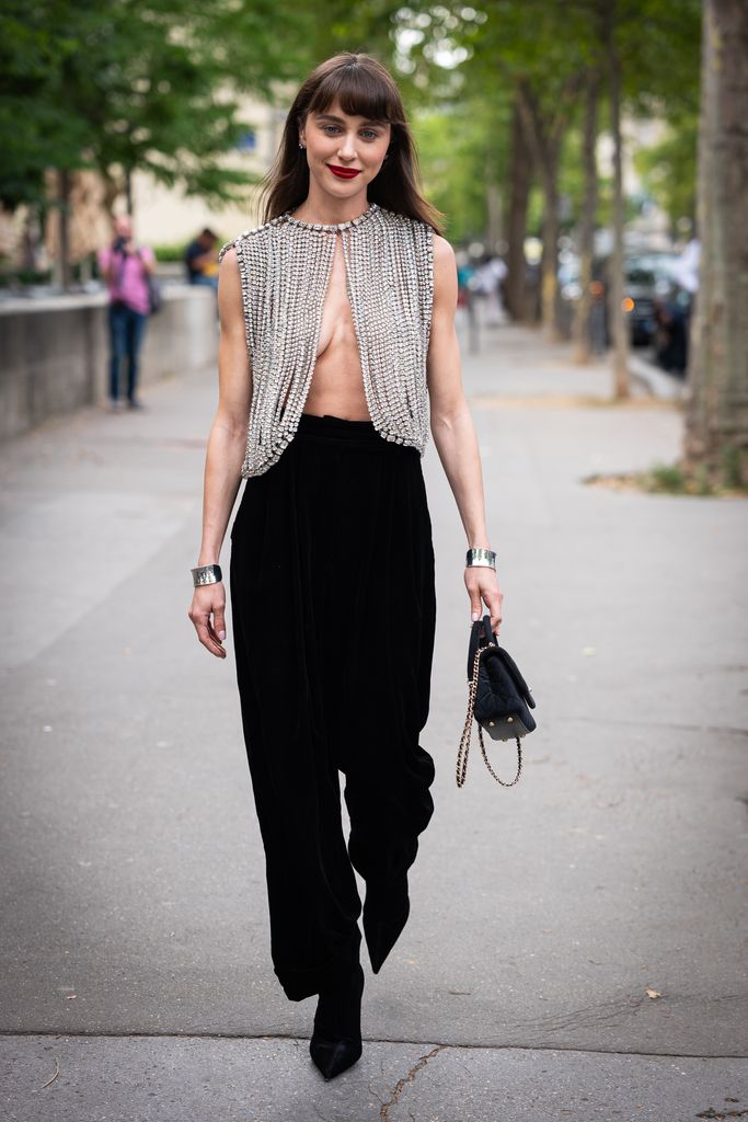 Mary Leest wears a crystals top, black pants, black bag and silver bracelets, outside Alexandre Vauthier, during the Haute Couture Fall/Winter 2023/2024 as part of  Paris Fashion Week on July 04, 2023 in Paris, France