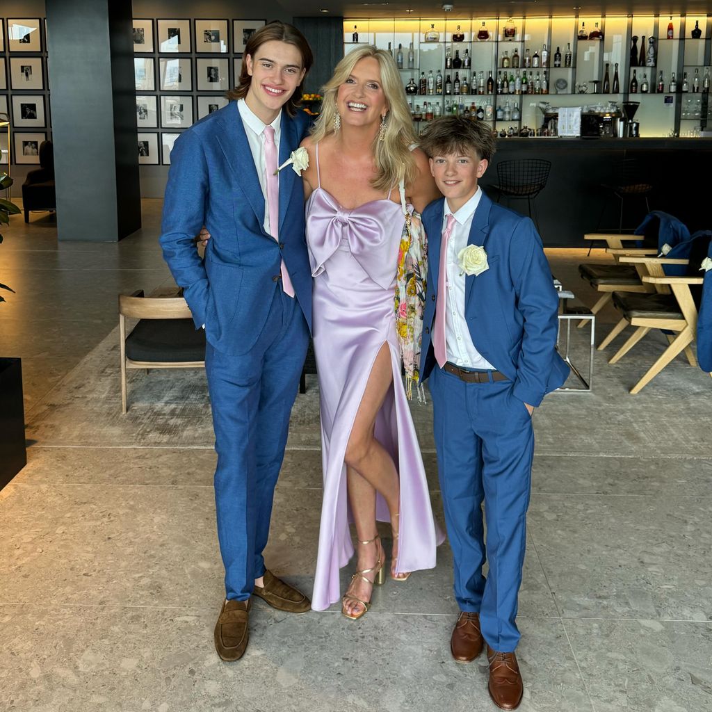 Penny Lancaster in lilac with two sons