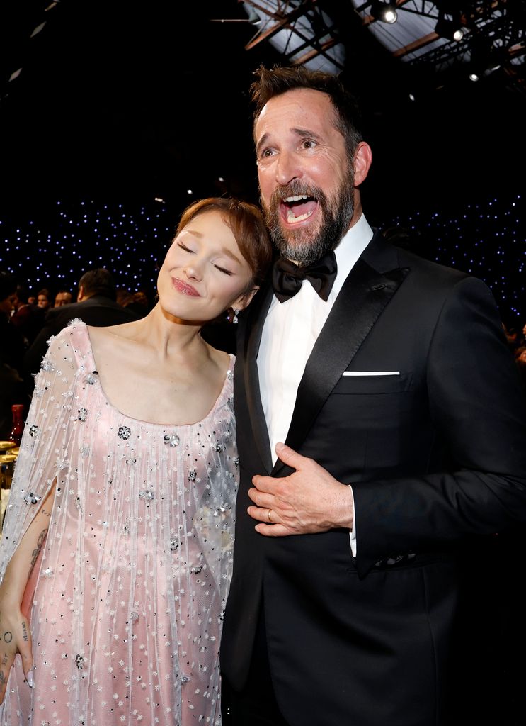 woman in pink dress hugging man in suit