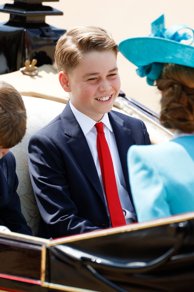 Prince George smiling in carriage