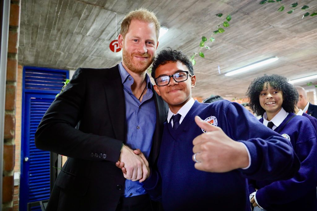 Prince Harry shakes hands with Colombian student