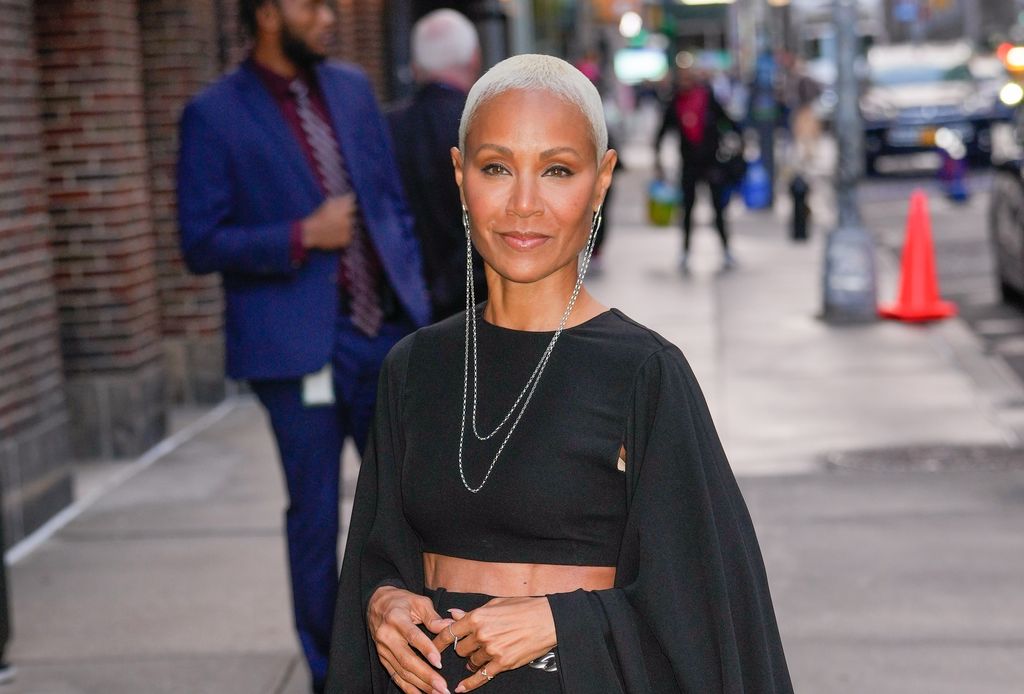 Jada Pinkett Smith smiling in a black crop top 