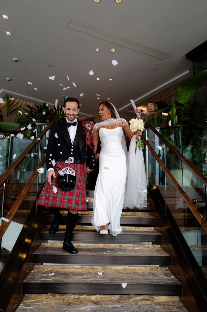 Mel B looking shocked towards her husband Rory as they were showered with confetti