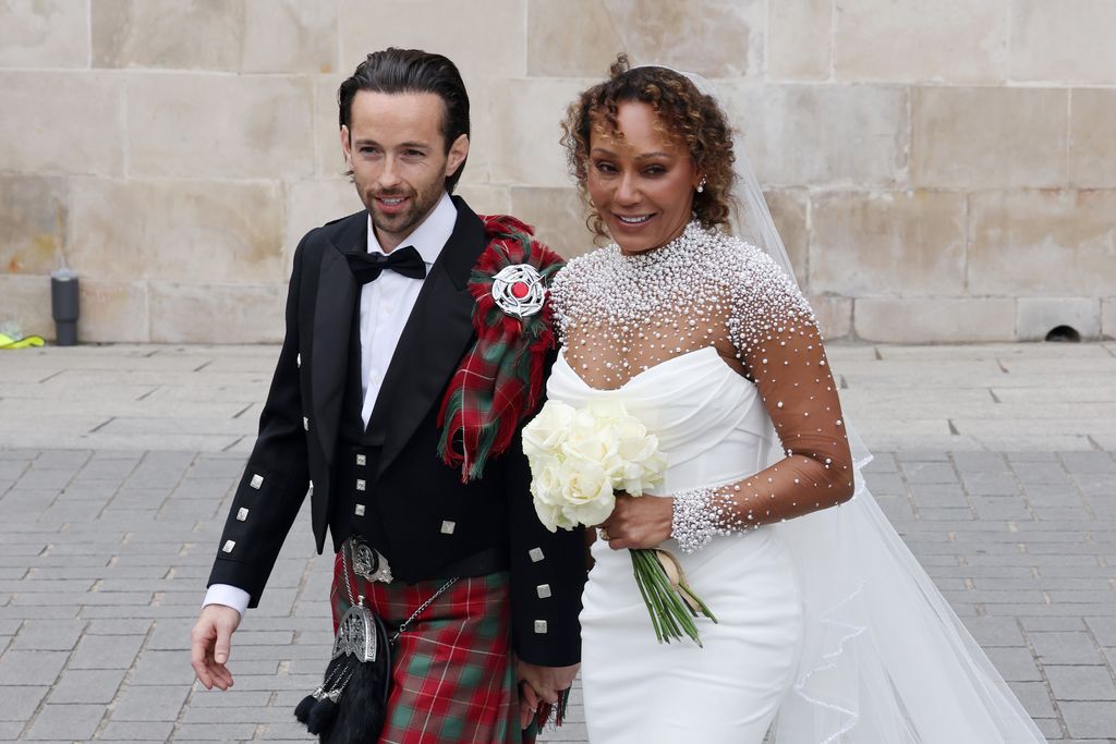 rory McPhee standing with Mel B in a wedding dress
