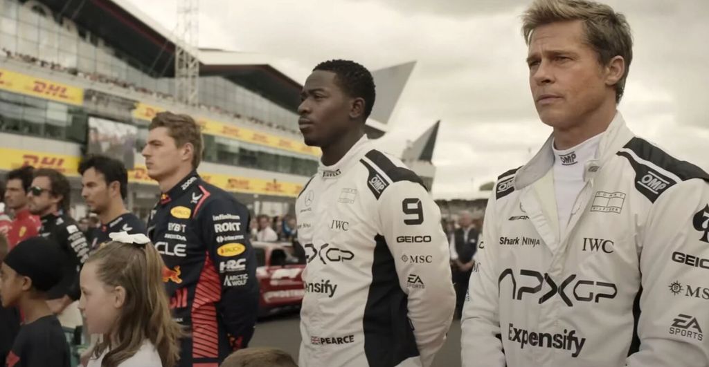 Damson Idris and Brad Pitt standing in a line with Carlos Sainz Jr, Fernando Alonso, Sergio Perez and Max Verstappen
