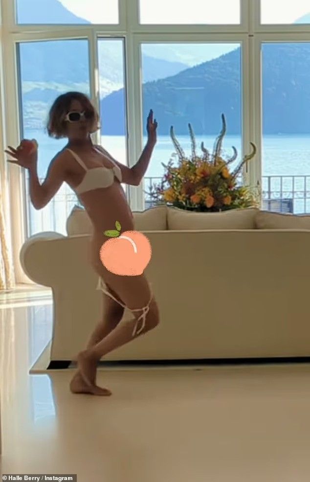 halle berry in bikini with peach emoji covering her lower half