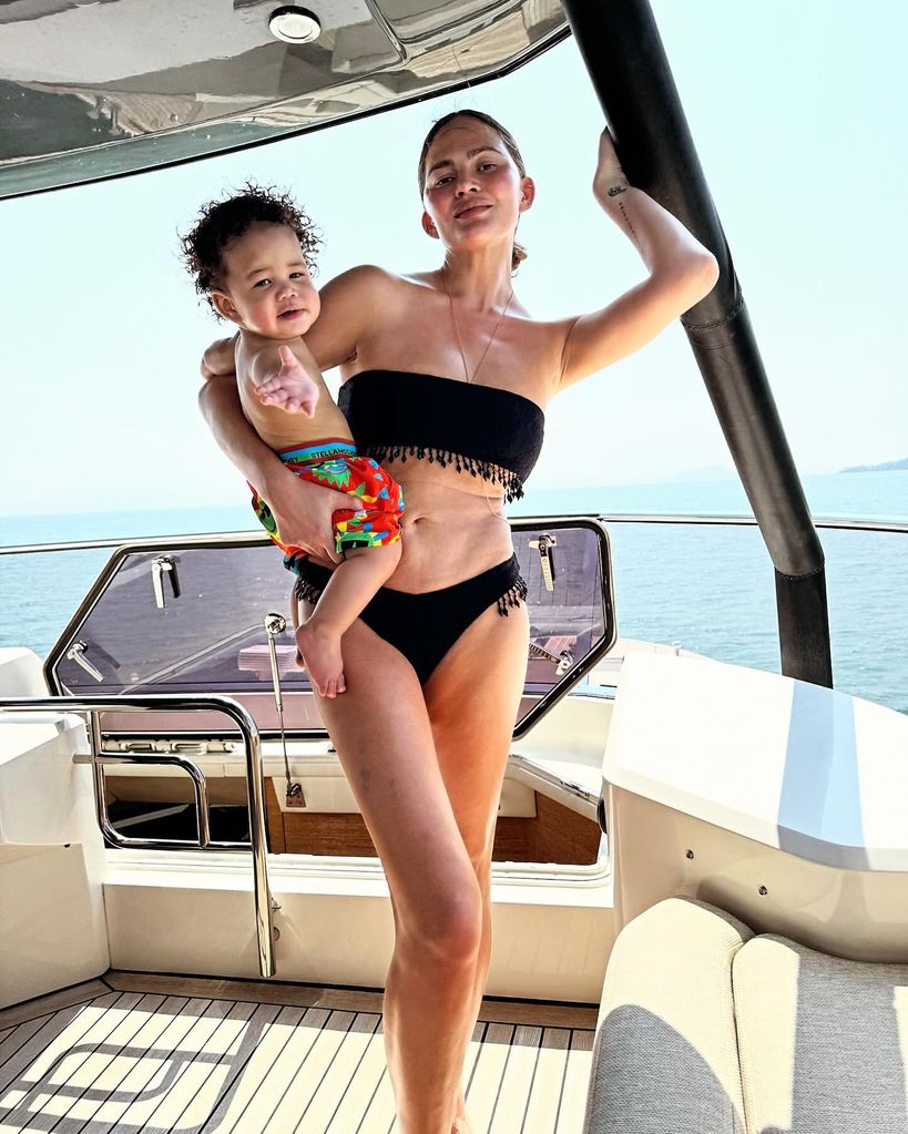 Chrissy Teigen unairbrushed bikini photo in black swimwear with baby son Wren