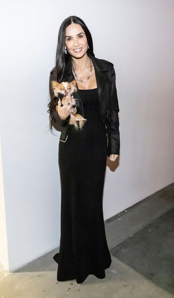 Demi Moore in black dress holding chihuahua