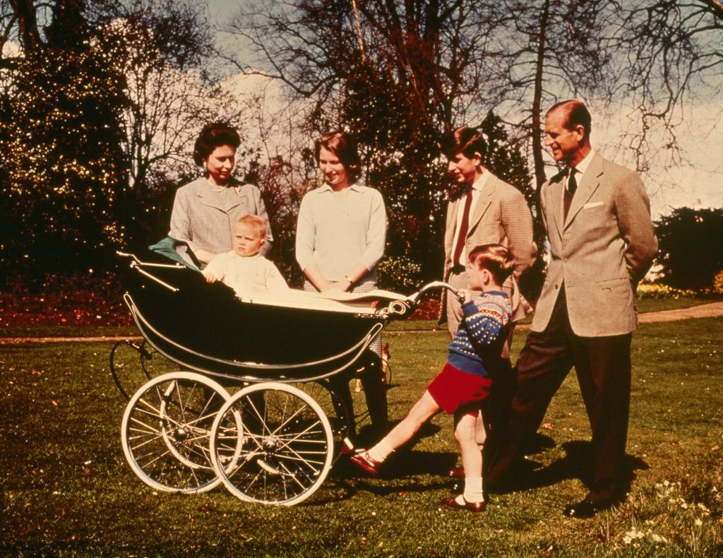 The Queen, Princess Anne, Prince Charles, Prince Philip and Prince Andrew looking at a baby Prince Edward in a pram