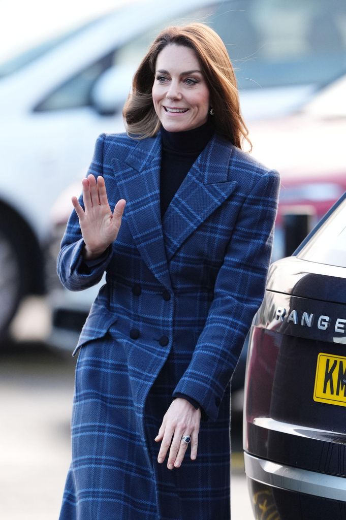 Kate Middleton walking in a tartan overcoat