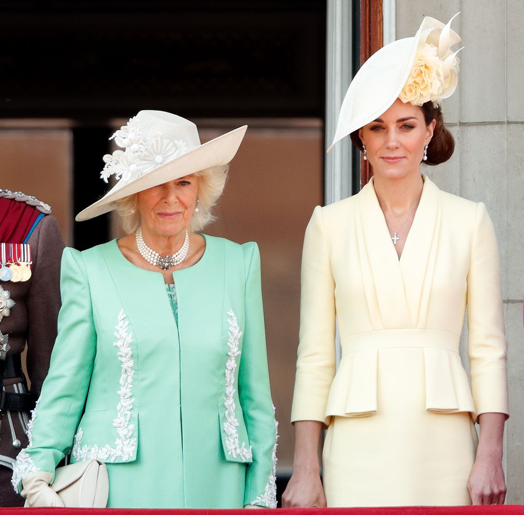 Camilla, Duchess of Cornwall in mint dress and Catherine on balcony