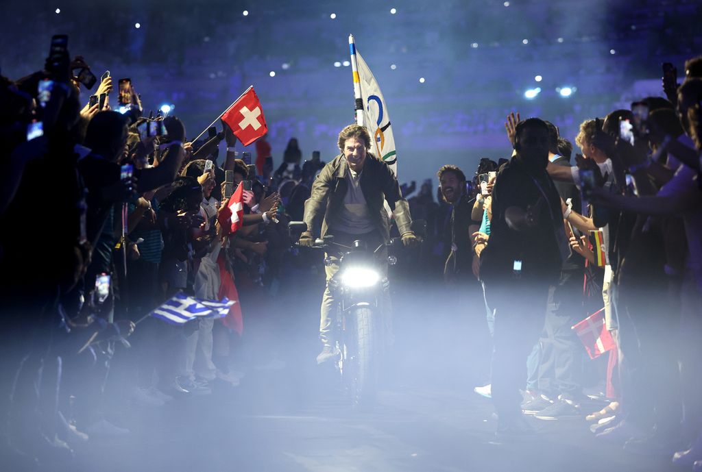  Tom Cruise rides on a Motorbike with the IOC Flag during the Closing Ceremony of the Olympic Games Paris 