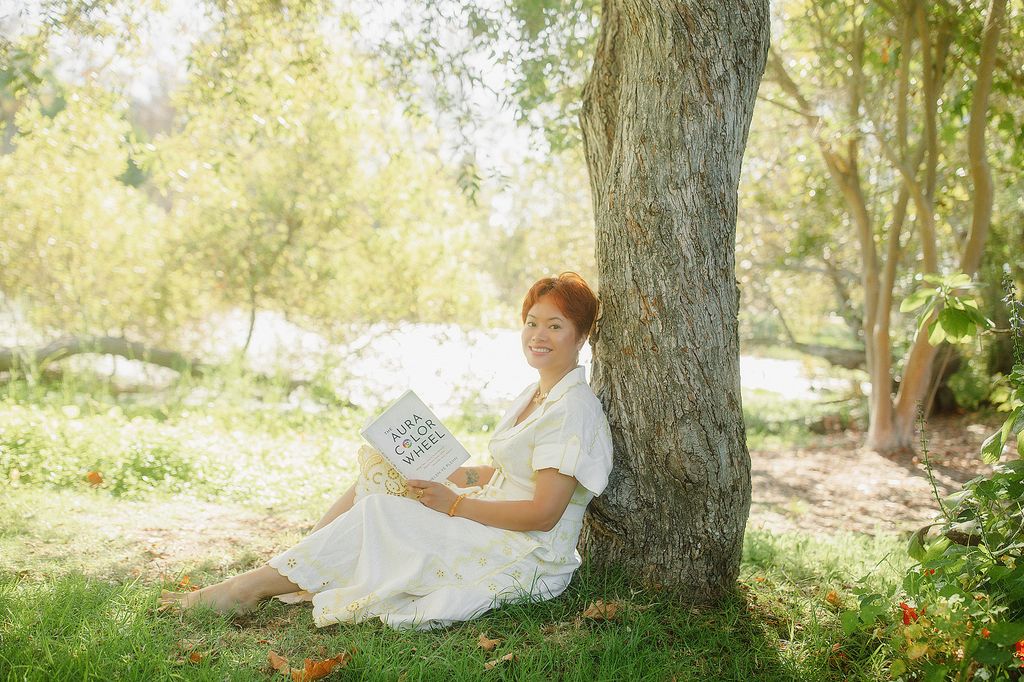 Helen reading her book under a tree