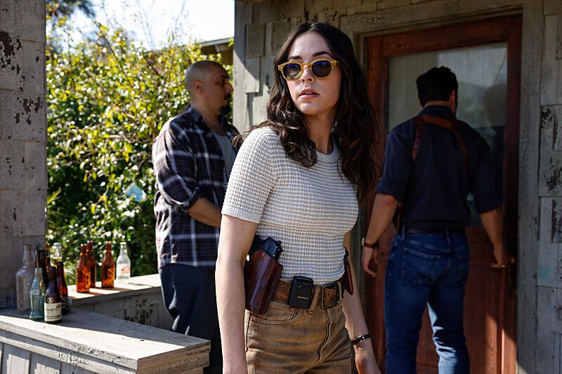 woman in glasses with gun in holster