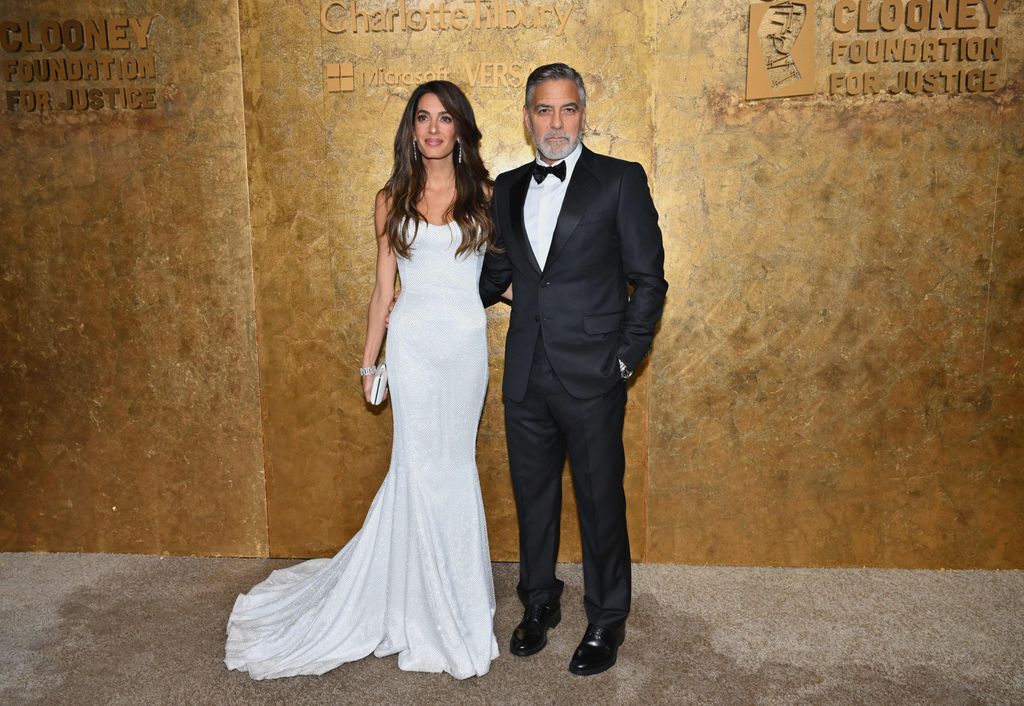 Lebanese-British barrister Amal Clooney (L) and husband US actor George Clooney arrive for The Albies hosted by the Clooney Foundation at the New York Public Library in New York City 