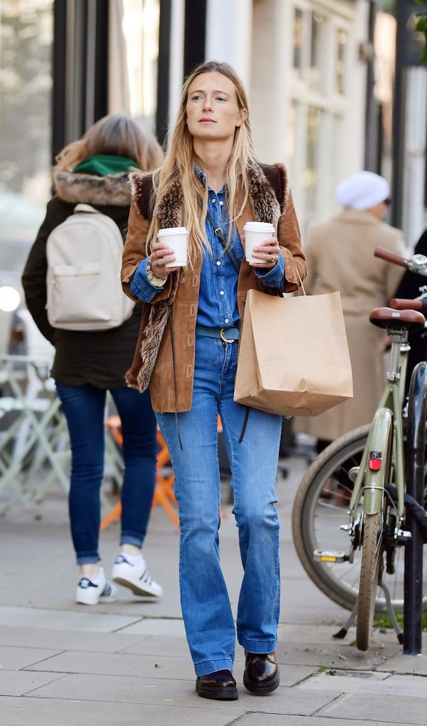 Alizee Thevenet wearing double denim and holding two coffees