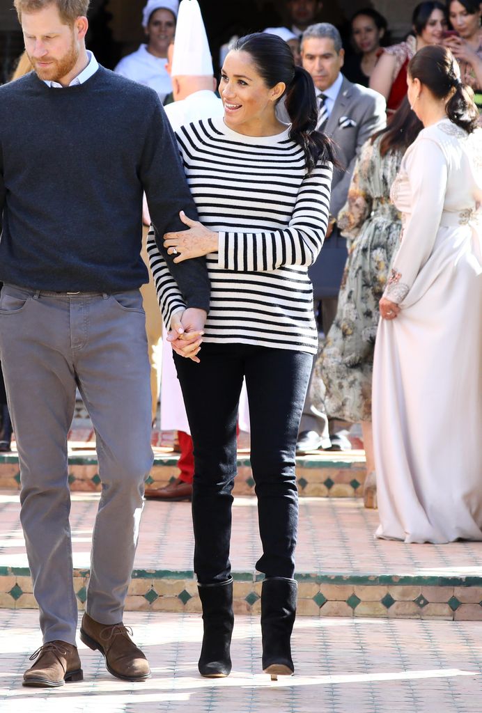 Meghan wore a Breton top with jeans and suede boots for an outing in Morocco