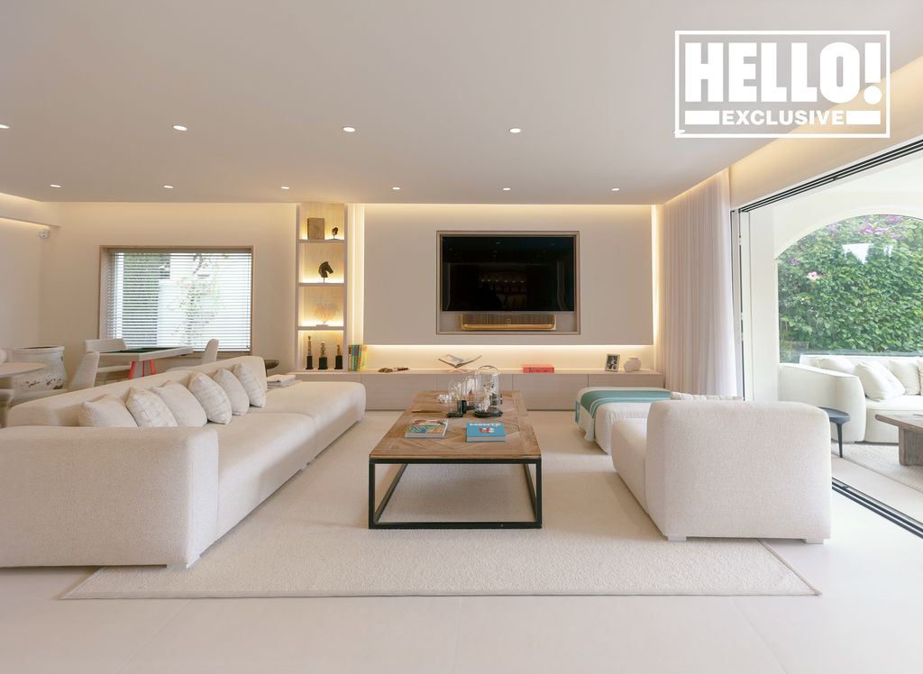 Eva Longoria and Jose Baston stunning living room with long white couch coffee table and television