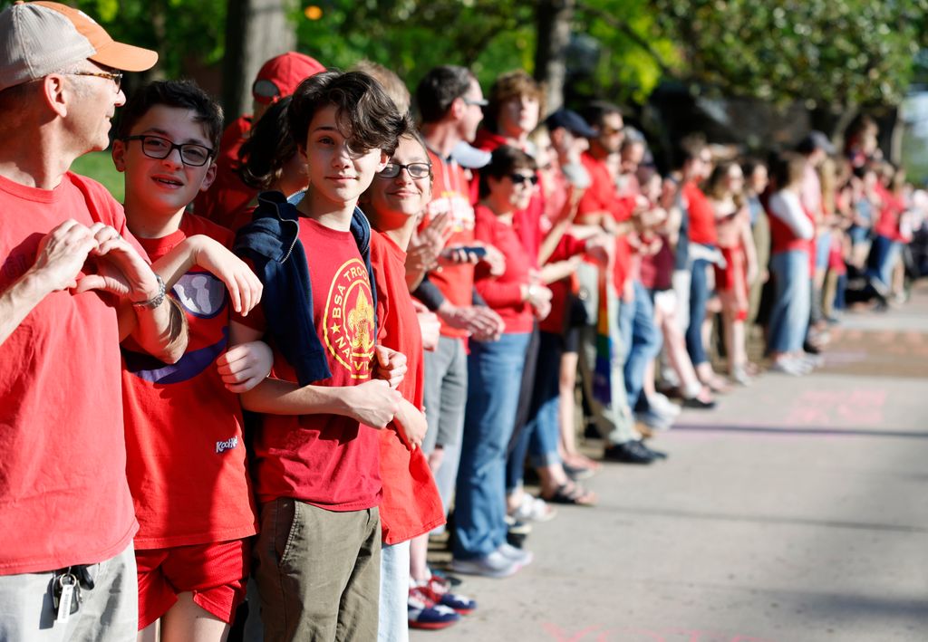 Children participate in a demonstration of linking arms in support of gun control laws